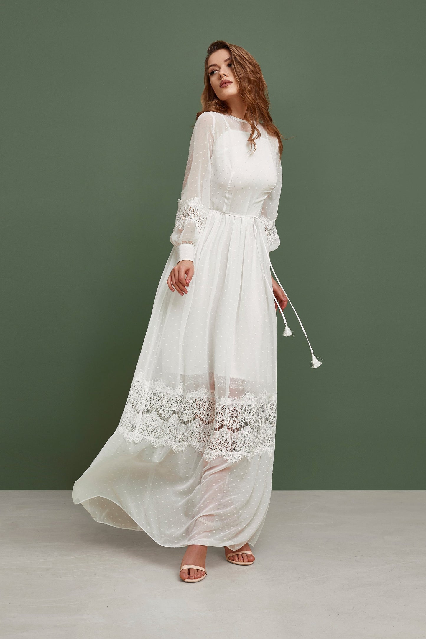Rustic wedding dress with white polka dot print. The dress is fit and flare silhouette, has long sleeves and ankle length skirt.
it has bohemian lace touch and small belt.
Perfect for modest bride.