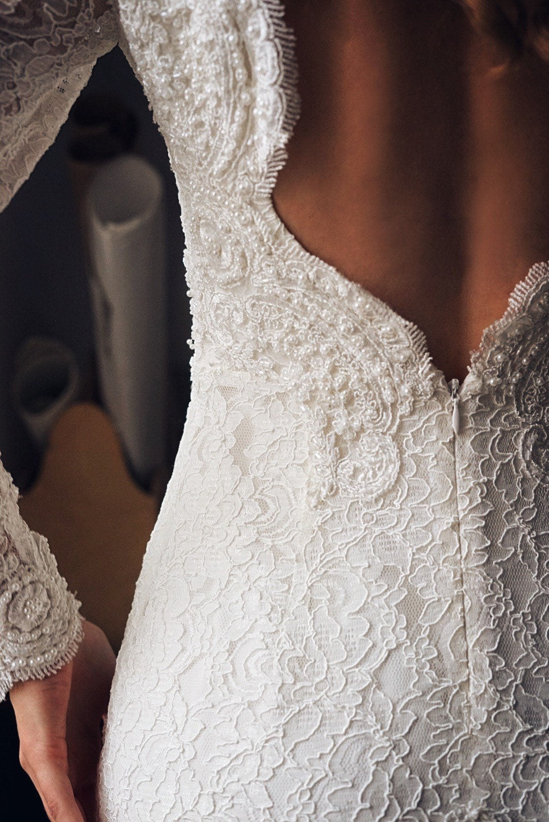 Open back of this mermaid gown is heavy embroidered with pearls an sequins.