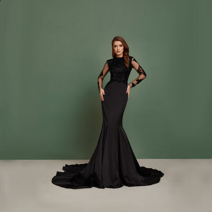 Black wedding dress with long sleeves, mermaid silhouette, open back and long train. Dress is hand embroidered with beads and sequins.