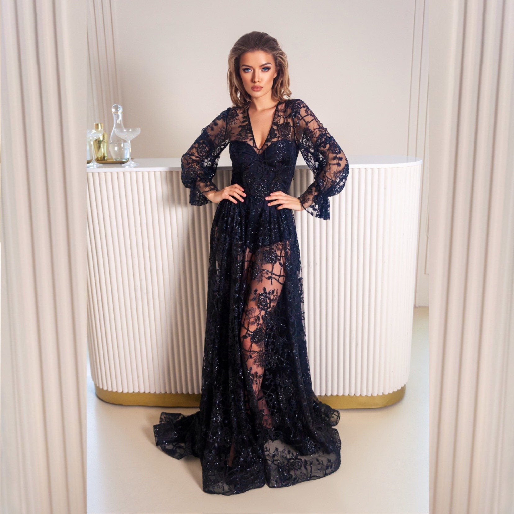 Black wedding dress with long puffy sleeves and fit and flare skirt with  dramatic train. Floral glitter pattern. The dress is completed with silk bodysuit or slip dress. Perfect for goth bride and good choice for prom or any special occasion event.