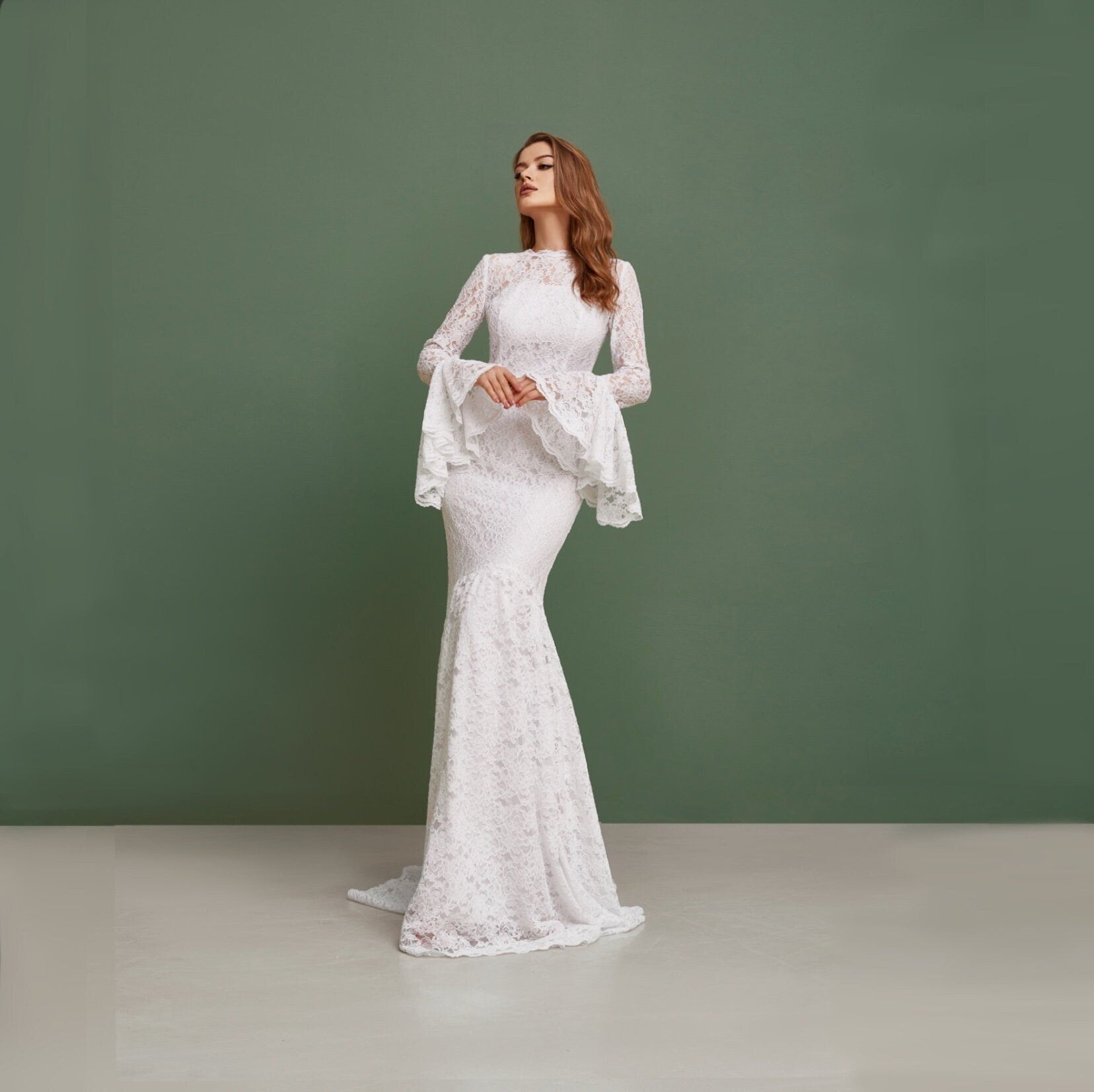 Simple wedding dress with bell sleeves and train. Mermaid silhouette is perfect for bohemian bride. Made from cord lace with pearl buttons on the back.