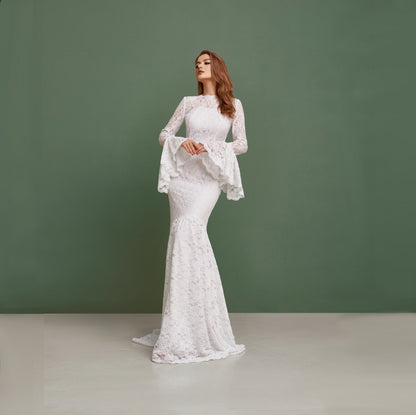 Simple wedding dress with bell sleeves and train. Mermaid silhouette is perfect for bohemian bride. Made from cord lace with pearl buttons on the back.