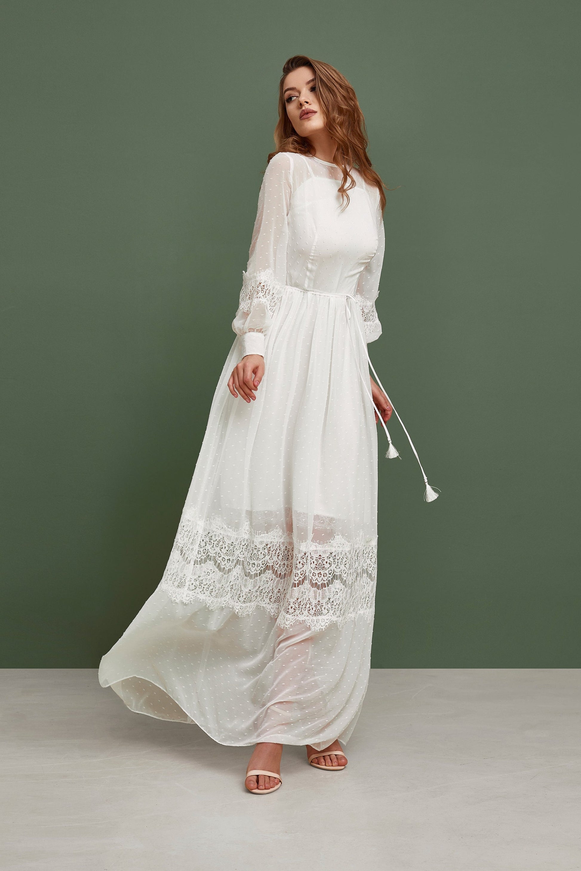 Rustic wedding dress with white polka dot print. The dress is fit and flare silhouette, has long sleeves and ankle length skirt.
it has bohemian lace touch and small belt.
Perfect for modest bride.